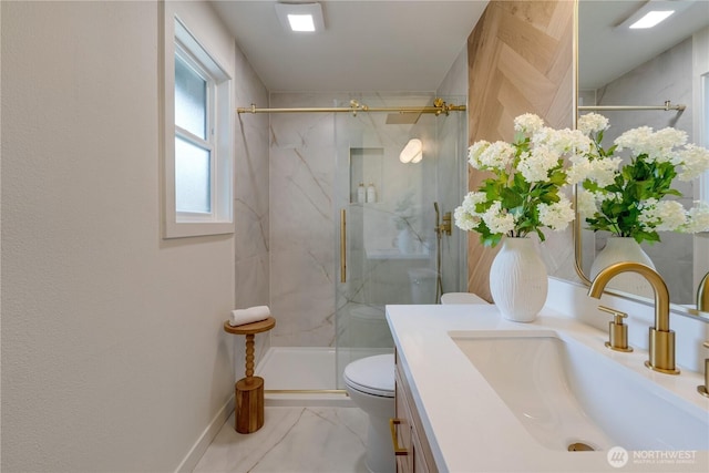 bathroom featuring vanity, a marble finish shower, toilet, marble finish flooring, and baseboards