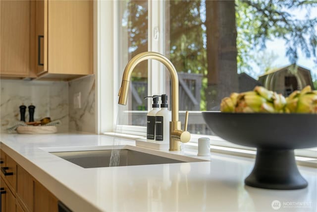 kitchen view of decorative backsplash, light countertops, and brown cabinets