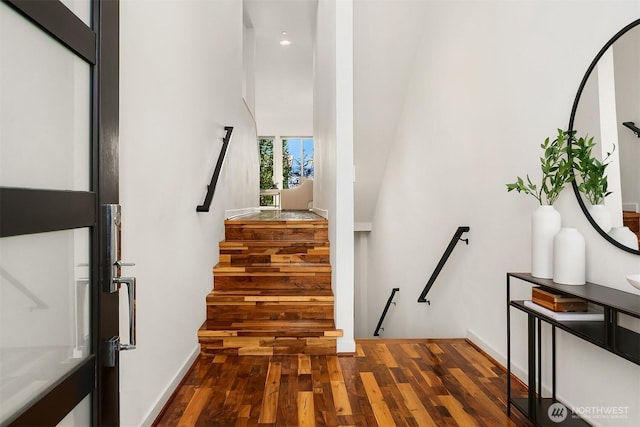 staircase with recessed lighting, baseboards, and wood finished floors