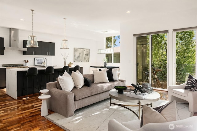 living room featuring a wealth of natural light, wood finished floors, and recessed lighting