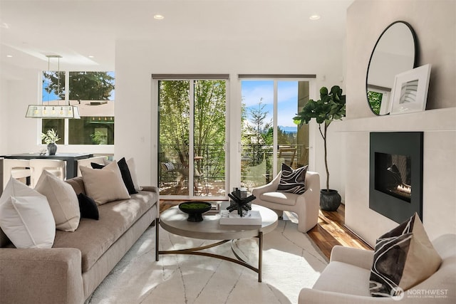 living room with a glass covered fireplace and recessed lighting