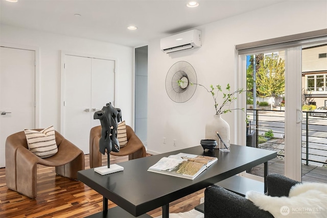 office space featuring a wall mounted air conditioner, recessed lighting, and wood finished floors