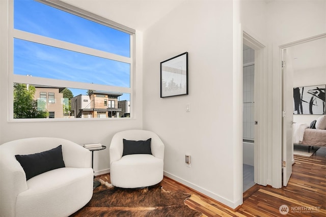 living area with wood finished floors and baseboards