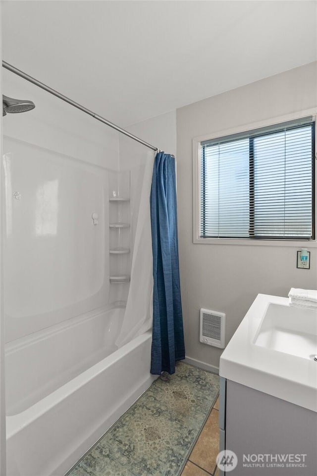 full bathroom with shower / bath combo with shower curtain, tile patterned flooring, baseboards, and vanity