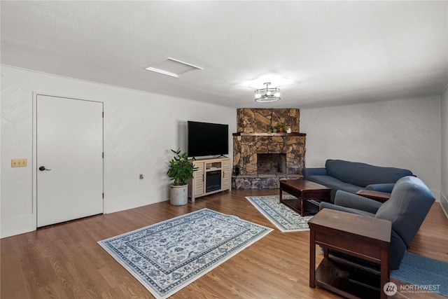 living room featuring a fireplace and wood finished floors