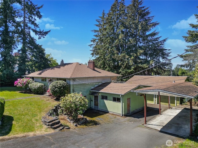 2734 Sunset Dr W, University Place, WA 98466 - view of front of property with roof with shingles, aphalt driveway, a front yard, a carport, and a chimney