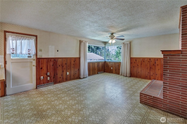 2734 Sunset Dr W, University Place, WA 98466 - unfurnished room with wainscoting, baseboard heating, and a textured ceiling