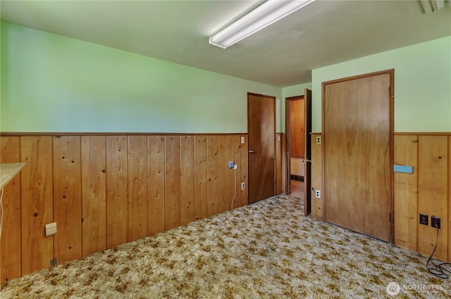 2734 Sunset Dr W, University Place, WA 98466 - carpeted spare room featuring wood walls and a wainscoted wall