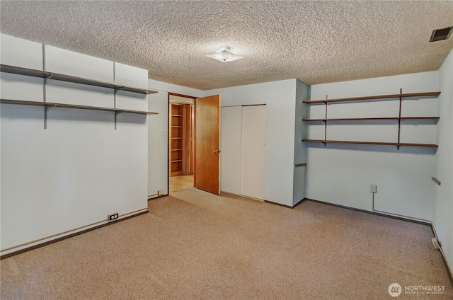 2734 Sunset Dr W, University Place, WA 98466 - unfurnished bedroom featuring a textured ceiling, carpet floors, a closet, and visible vents