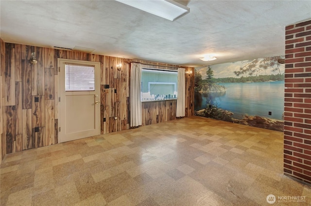 2734 Sunset Dr W, University Place, WA 98466 - spare room with a water view, wooden walls, and tile patterned floors