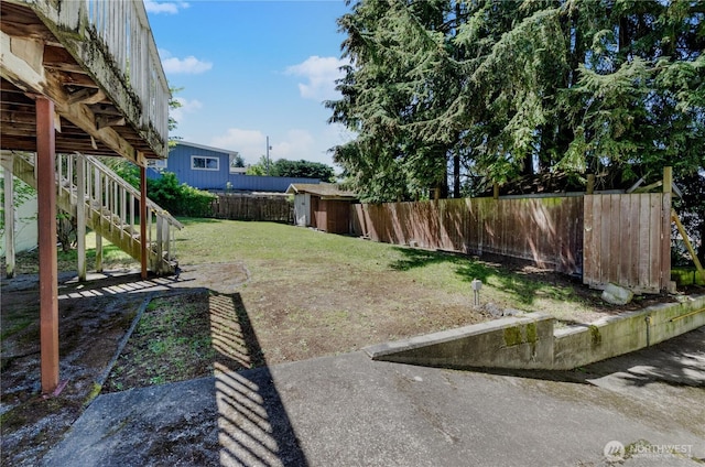 2734 Sunset Dr W, University Place, WA 98466 - view of yard featuring stairs, an outdoor structure, a fenced backyard, and a storage unit