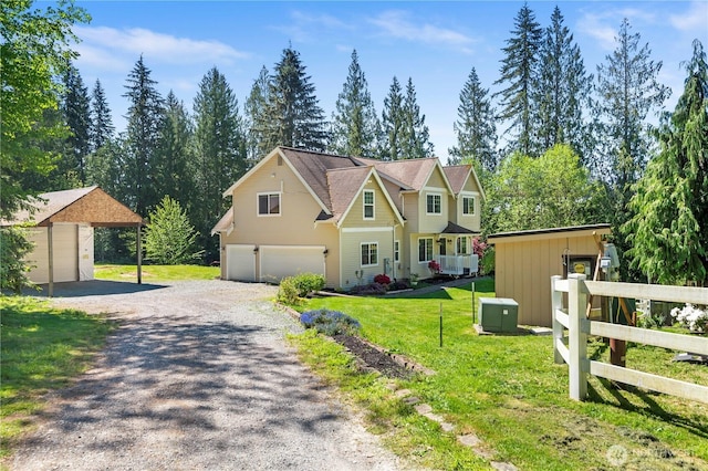 view of front of property featuring an attached garage, gravel driveway, an outdoor structure, and board and batten siding