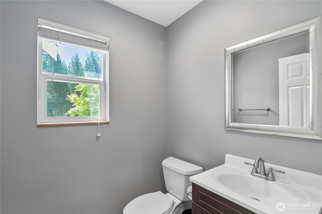 bathroom featuring toilet and vanity