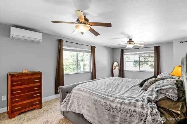 bedroom featuring a wall unit AC, multiple windows, light carpet, and baseboards