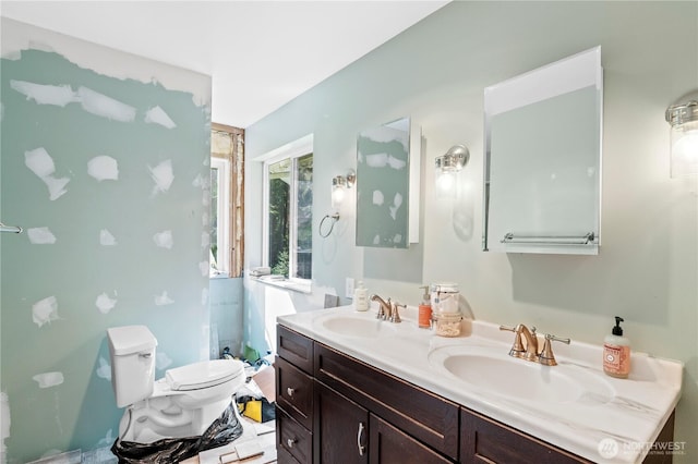 full bathroom featuring toilet and double vanity