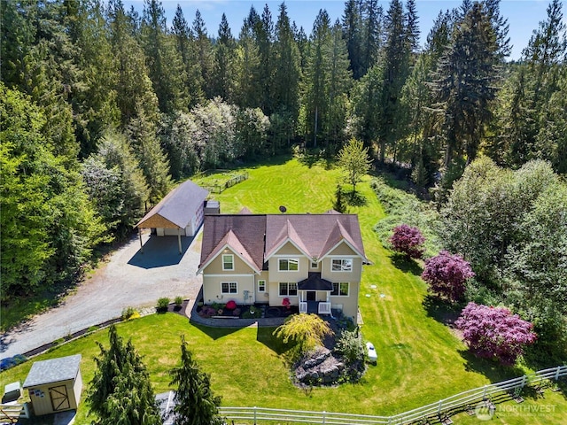 view of subject property featuring a heavily wooded area