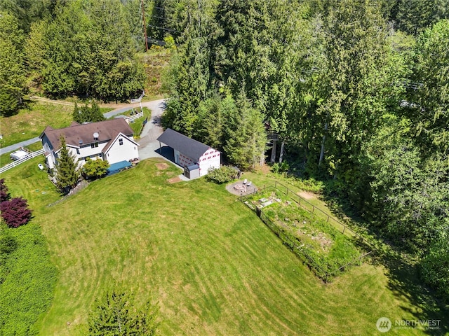 aerial view of property and surrounding area featuring a heavily wooded area