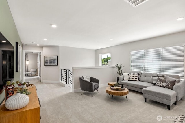 living area featuring light colored carpet, baseboards, and recessed lighting