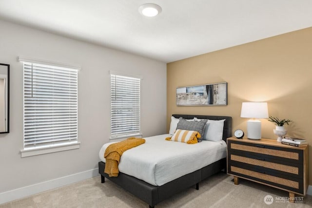 carpeted bedroom featuring baseboards