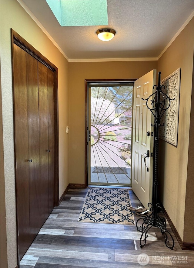 70 Cedar Hill Ln, Sequim, WA 98382 - foyer entrance featuring dark wood-type flooring, ornamental molding, baseboards, and a textured ceiling