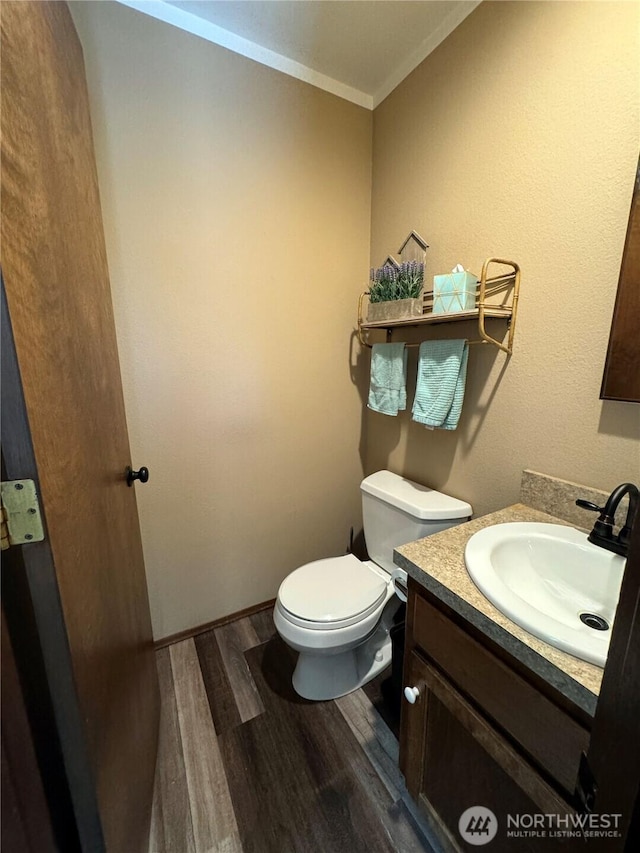 70 Cedar Hill Ln, Sequim, WA 98382 - bathroom featuring wood finished floors, toilet, ornamental molding, and vanity
