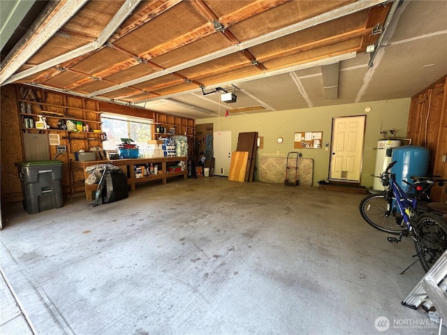 70 Cedar Hill Ln, Sequim, WA 98382 - garage with water heater, a workshop area, and a garage door opener