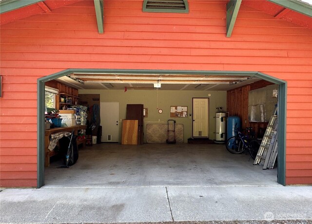 70 Cedar Hill Ln, Sequim, WA 98382 - garage featuring strapped water heater and a garage door opener