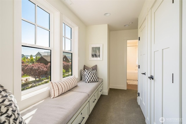 living area featuring dark colored carpet, baseboards, and recessed lighting