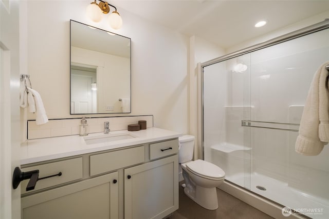 full bath featuring a shower stall, toilet, and vanity