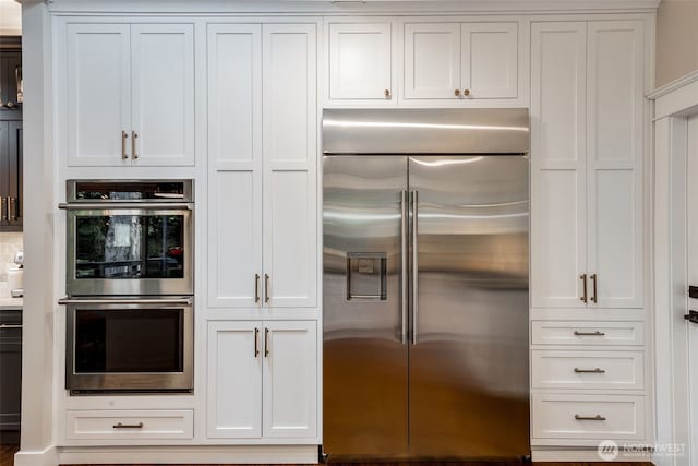 kitchen featuring stainless steel appliances and white cabinets