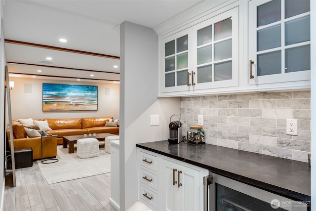 indoor dry bar featuring light wood-style flooring, tasteful backsplash, recessed lighting, and wine cooler