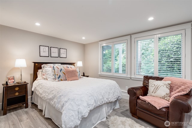 bedroom featuring light wood-type flooring, baseboards, multiple windows, and recessed lighting