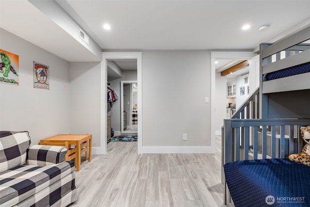 bedroom with light wood-type flooring, baseboards, and recessed lighting