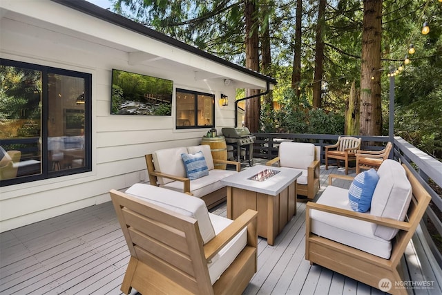 deck featuring an outdoor living space with a fire pit and grilling area