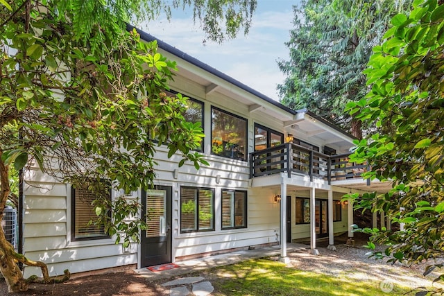 back of property featuring a deck