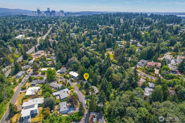 aerial view of property and surrounding area with a forest