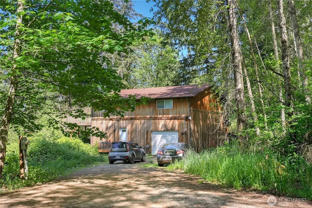 view of outbuilding featuring driveway and a garage