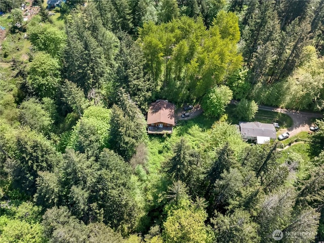aerial overview of property's location featuring a heavily wooded area