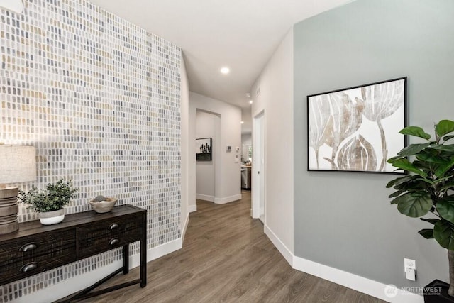 corridor with recessed lighting, baseboards, and wood finished floors