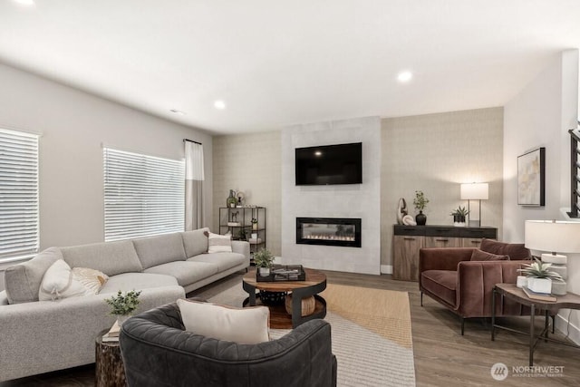 living room with wood finished floors, a fireplace, and recessed lighting