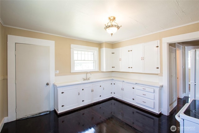 618 Coolidge Rd, Aberdeen, WA 98520 - kitchen with white electric range, white cabinets, ornamental molding, dark wood-type flooring, and light countertops