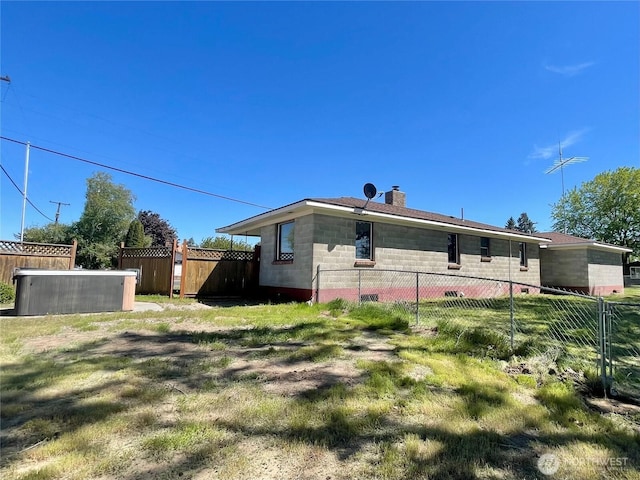 back of house with a chimney and fence
