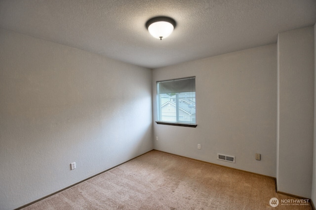 4323 Beaumont Ln SE, Lacey, WA 98503 - unfurnished room with light colored carpet and a textured ceiling