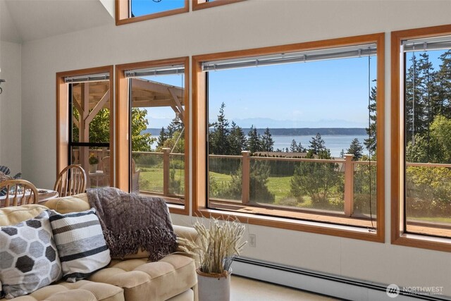 565 Olympic View Ln, Camano Island, WA 98282 - sunroom with a baseboard heating unit, a water view, and lofted ceiling