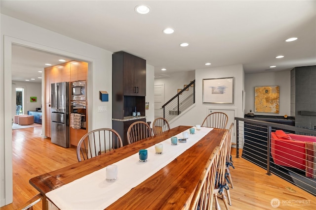 dining space featuring stairway, recessed lighting, and light wood-style floors