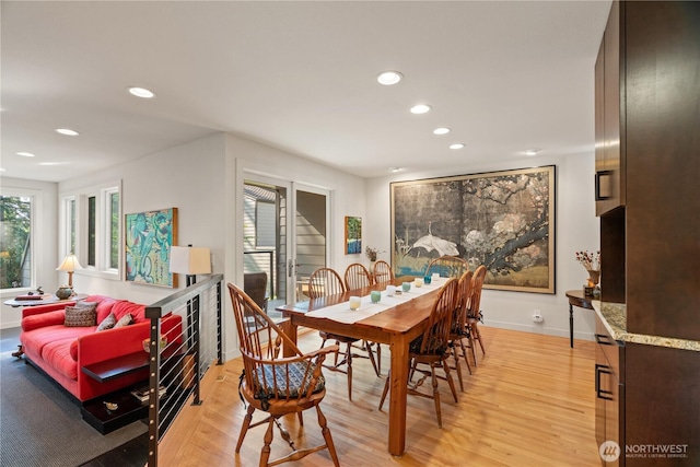 dining space with baseboards, light wood-style flooring, and recessed lighting