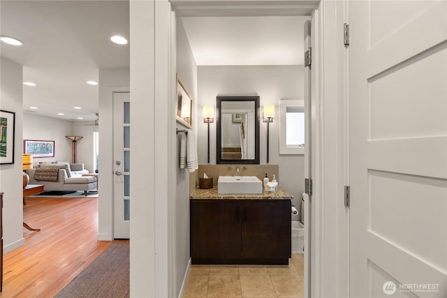 bathroom with vanity, recessed lighting, and wood finished floors