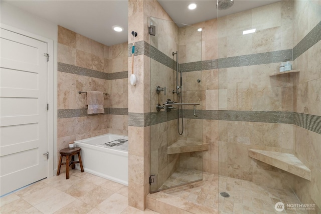 bathroom featuring a stall shower, a garden tub, and recessed lighting