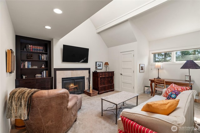 living area featuring a tiled fireplace, built in features, light colored carpet, vaulted ceiling, and recessed lighting