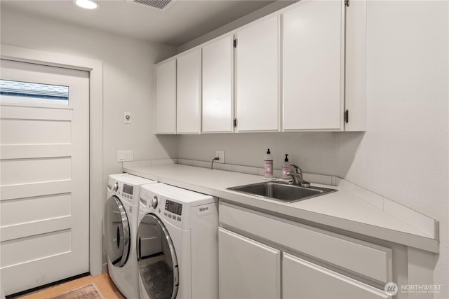laundry room featuring a sink, cabinet space, independent washer and dryer, and recessed lighting